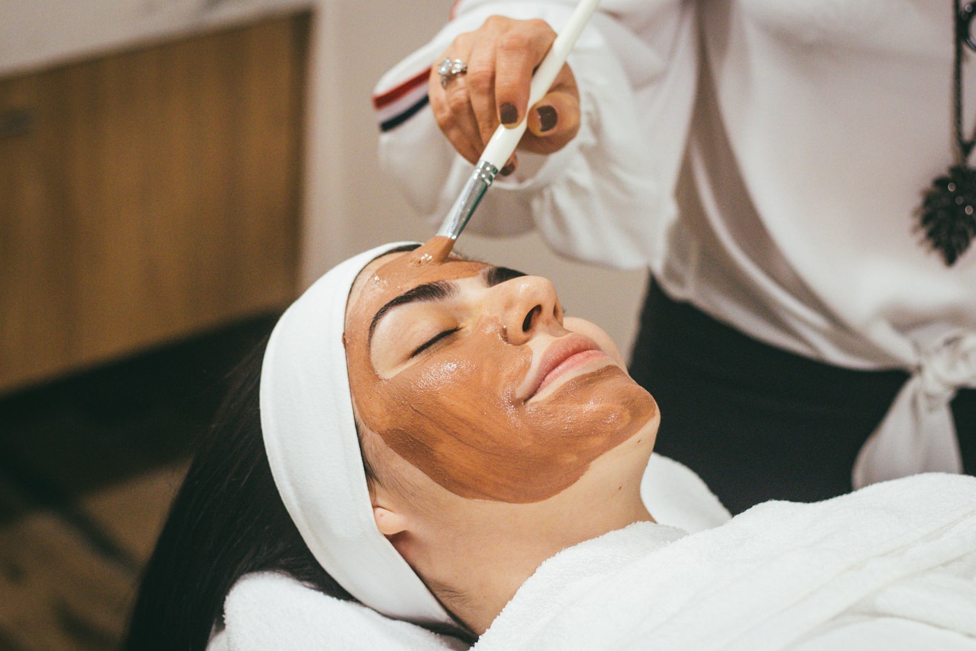 A client relaxing during a facial skincare treatment